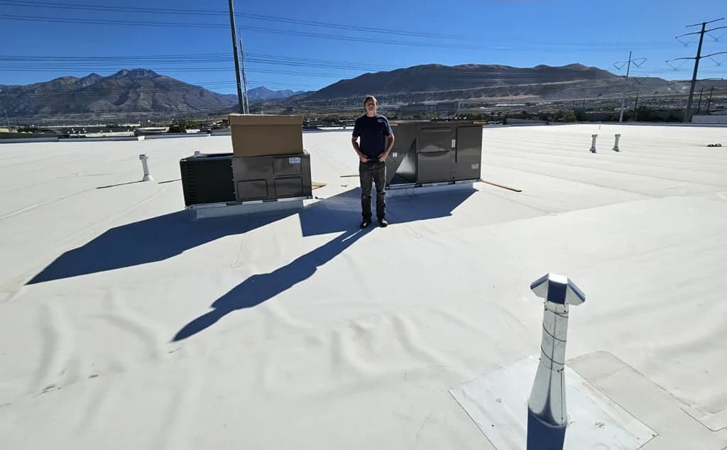 Technician servicing rooftop unit